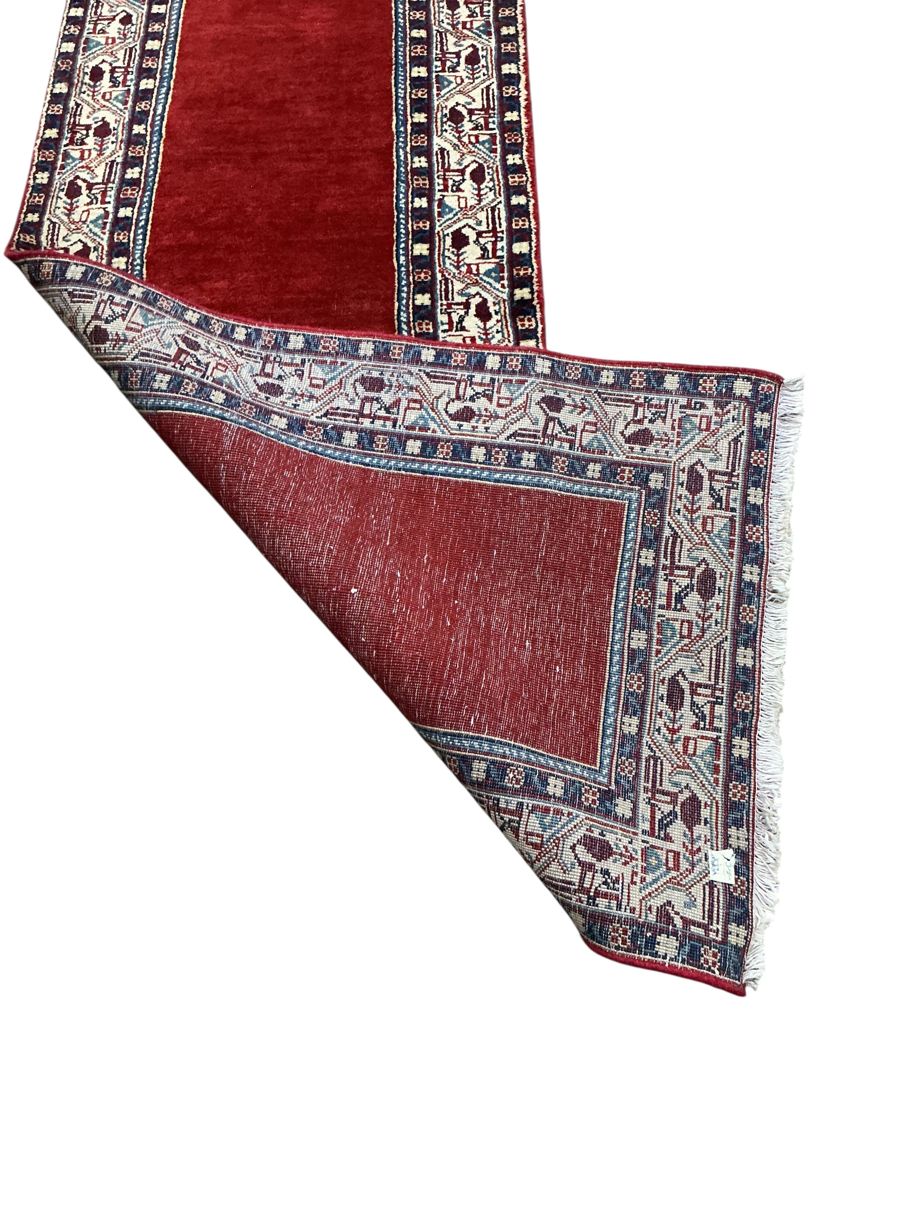 An Araak red ground runner, 440 x 76cm